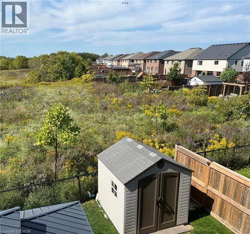 Shows the beauty of the greenspace and planted trees beyond the fence area. - 115 Larry Crescent, Caledonia, ON - Outdoor