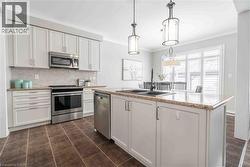Alternate view of kitchen showing ample cabinetry, crown molding and easy access to living spaces beyond. - 