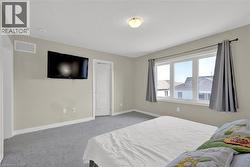 Carpeted bedroom with baseboards - 