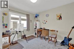 Office area featuring light carpet and baseboards - 