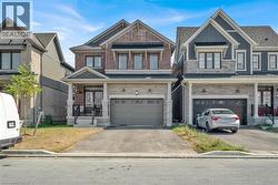 Craftsman inspired home featuring asphalt driveway, an attached garage, brick siding, and board and batten siding - 