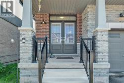 Doorway to property with french doors, brick siding, and a porch - 