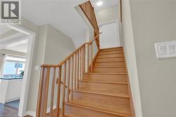 Stairway featuring baseboards and wood finished floors - 