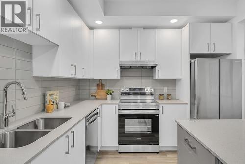 Kitchen - photos are of our showhome - 1057 Frost Road Unit# 317, Kelowna, BC - Indoor Photo Showing Kitchen With Double Sink With Upgraded Kitchen