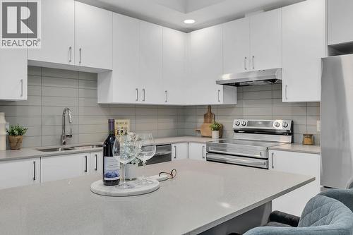 photos are of our showhome - 1057 Frost Road Unit# 317, Kelowna, BC - Indoor Photo Showing Kitchen With Double Sink With Upgraded Kitchen