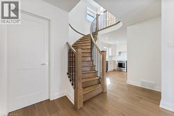 Staircase with wood finished floors and recessed lighting - 
