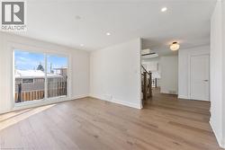 Spare room with stairs, recessed lighting, and light wood-style flooring - 