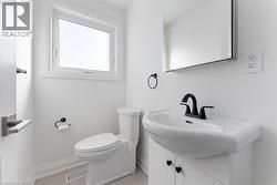 Half bath featuring vanity and baseboards - 