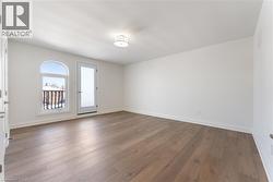 Spare room featuring wood-type flooring - 