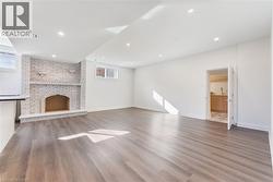 Unfurnished living room with light wood finished floors and recessed lighting - 