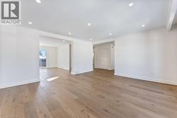 Spare room featuring light wood finished floors, crown molding, and recessed lighting - 