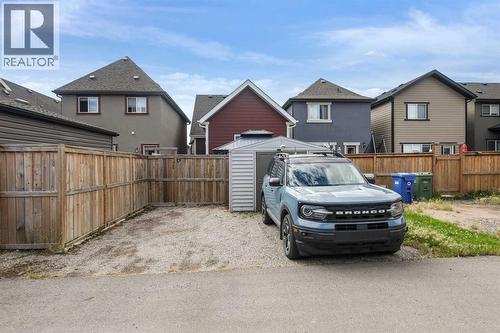 Fully fenced yard with enough space to park infront of the large storage shed - 103 Masters Heights Se, Calgary, AB - Outdoor