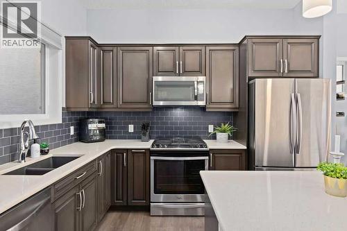 103 Masters Heights Se, Calgary, AB - Indoor Photo Showing Kitchen With Double Sink With Upgraded Kitchen