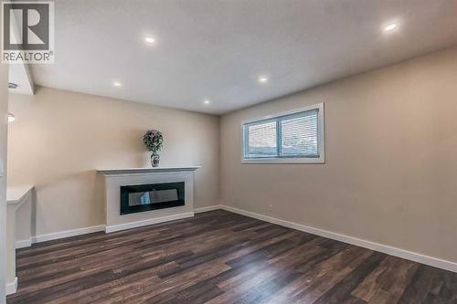 23 Cheltenham Road Nw, Calgary, AB - Indoor With Fireplace