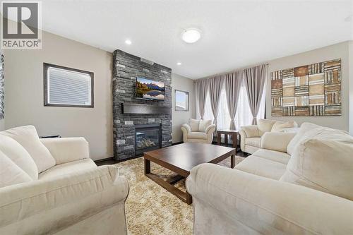 65 Elgin Meadows Circle Se, Calgary, AB - Indoor Photo Showing Living Room With Fireplace