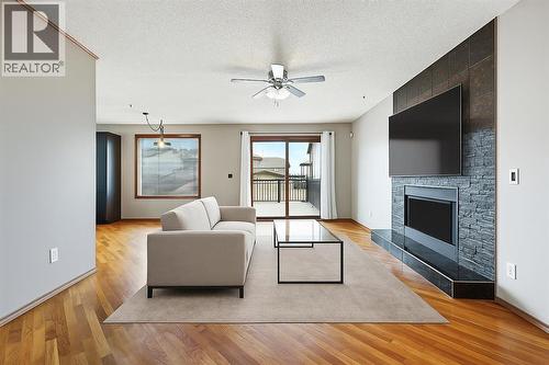 virtually staged - 128 Ventura Way Ne, Calgary, AB - Indoor Photo Showing Living Room With Fireplace