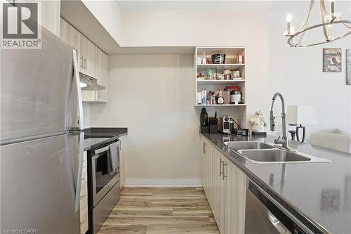 10 Concord Place Unit# 205, Grimsby, ON - Indoor Photo Showing Kitchen With Double Sink