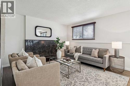 195 Lake Adams Crescent Se, Calgary, AB - Indoor Photo Showing Living Room With Fireplace
