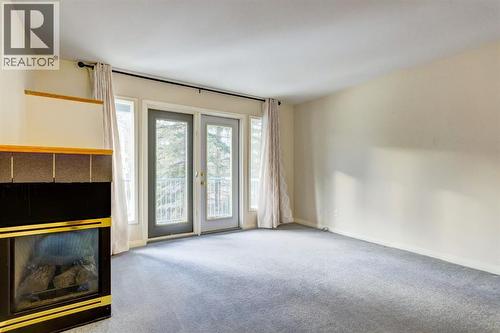 4, 704 8Th Avenue, Canmore, AB - Indoor Photo Showing Other Room With Fireplace