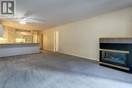 4, 704 8Th Avenue, Canmore, AB - Indoor Photo Showing Other Room With Fireplace