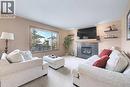 105 Citadel Crest Park Nw, Calgary, AB  - Indoor Photo Showing Living Room With Fireplace 