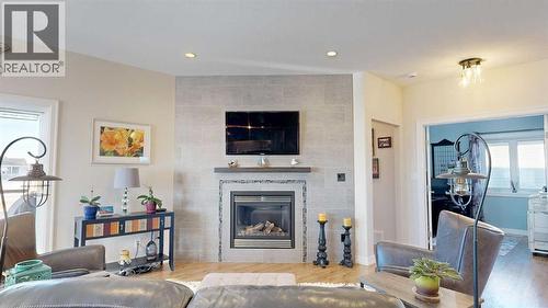 4020 Monarch Way, Stettler, AB - Indoor Photo Showing Living Room With Fireplace