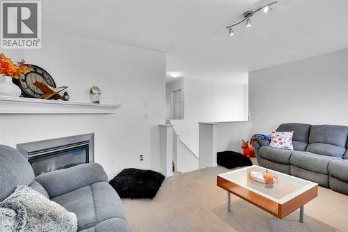 73 Covebrook Place Ne, Calgary, AB - Indoor Photo Showing Living Room With Fireplace
