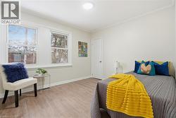 Bedroom with light wood-style floors and crown molding - 