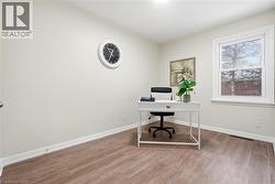 Office space featuring light wood finished floors and baseboards - 