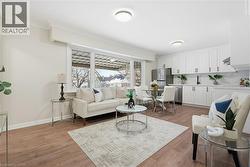 Living area with light wood finished floors and ornamental molding - 