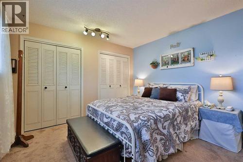 95 N 250 W, Raymond, AB - Indoor Photo Showing Bedroom