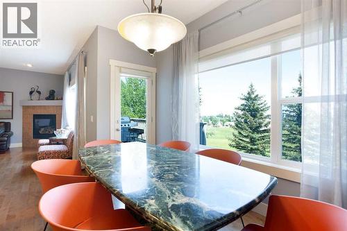 62 Panamount Road Nw, Calgary, AB - Indoor Photo Showing Dining Room With Fireplace