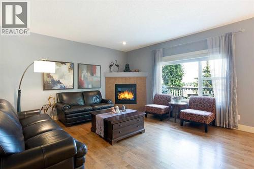 62 Panamount Road Nw, Calgary, AB - Indoor Photo Showing Living Room With Fireplace