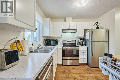2366 Eversyde Avenue Sw, Calgary, AB - Indoor Photo Showing Kitchen With Double Sink