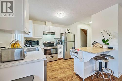 2366 Eversyde Avenue Sw, Calgary, AB - Indoor Photo Showing Kitchen With Double Sink