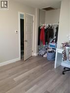 Bedroom with light wood-type flooring and ceiling fan - 