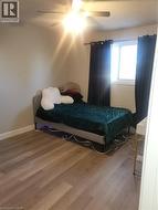 Bedroom with wood finished floors and ceiling fan - 