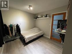 Bedroom featuring light wood-style floors and baseboards - 
