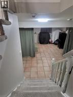 This family room, originally intended as a shared living space, is currently used as a bedroom and home office. It features a fireplace, adding warmth and character to the versatile layout, which comf - 