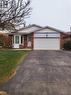 Backsplit home with an attached garage, brick siding, driveway, and a front lawn - 18 Rosewell Street, Hamilton, ON  - Outdoor 