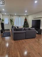 Living room with wood finished floors and recessed lighting - 