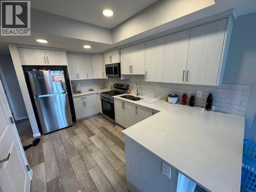 210 Lucas Close Nw, Calgary, AB - Indoor Photo Showing Kitchen With Stainless Steel Kitchen With Double Sink