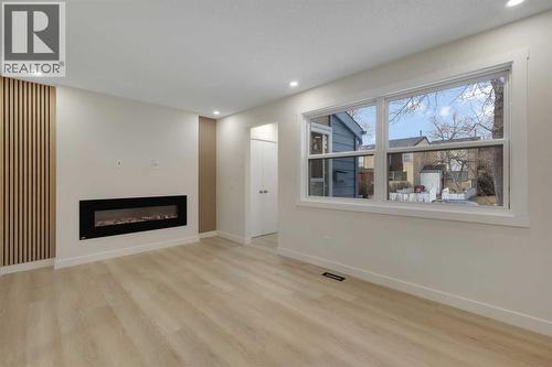13 Penworth Close Se, Calgary, AB - Indoor Photo Showing Living Room With Fireplace