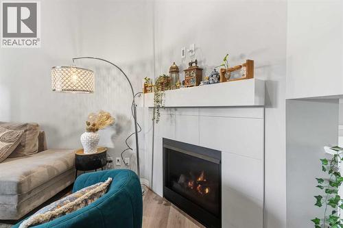 237 Windrow Crescent Sw, Airdrie, AB - Indoor Photo Showing Living Room With Fireplace