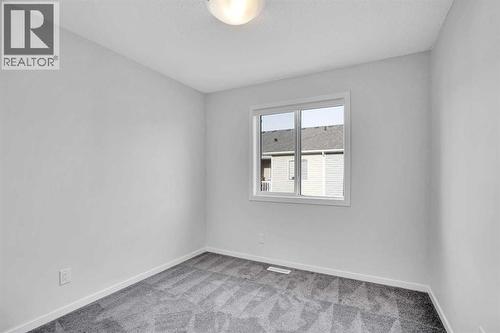 Bedroom 2 - 408 Windbury Link Sw, Airdrie, AB - Indoor Photo Showing Other Room