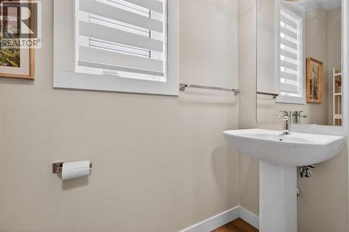 Bright 2-piece powder room off of the mudroom - 307 Precedence Hill, Cochrane, AB - Indoor Photo Showing Bathroom