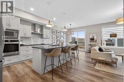 Open concept kitchen and living room with large island, and access to the private backyard - 