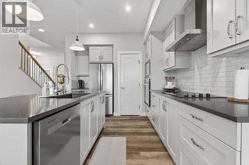 Neutral and warm chefs kitchen - 307 Precedence Hill, Cochrane, AB - Indoor Photo Showing Kitchen With Upgraded Kitchen