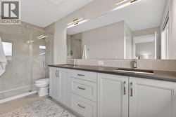 Newly updated chic ensuite with custom tiled shower with glass enclosure and double sinks - 