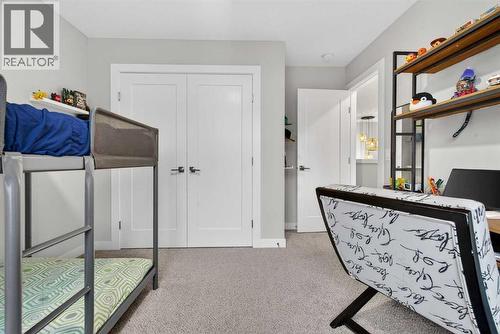 Second front bedroom with double door closet - 307 Precedence Hill, Cochrane, AB - Indoor Photo Showing Bedroom